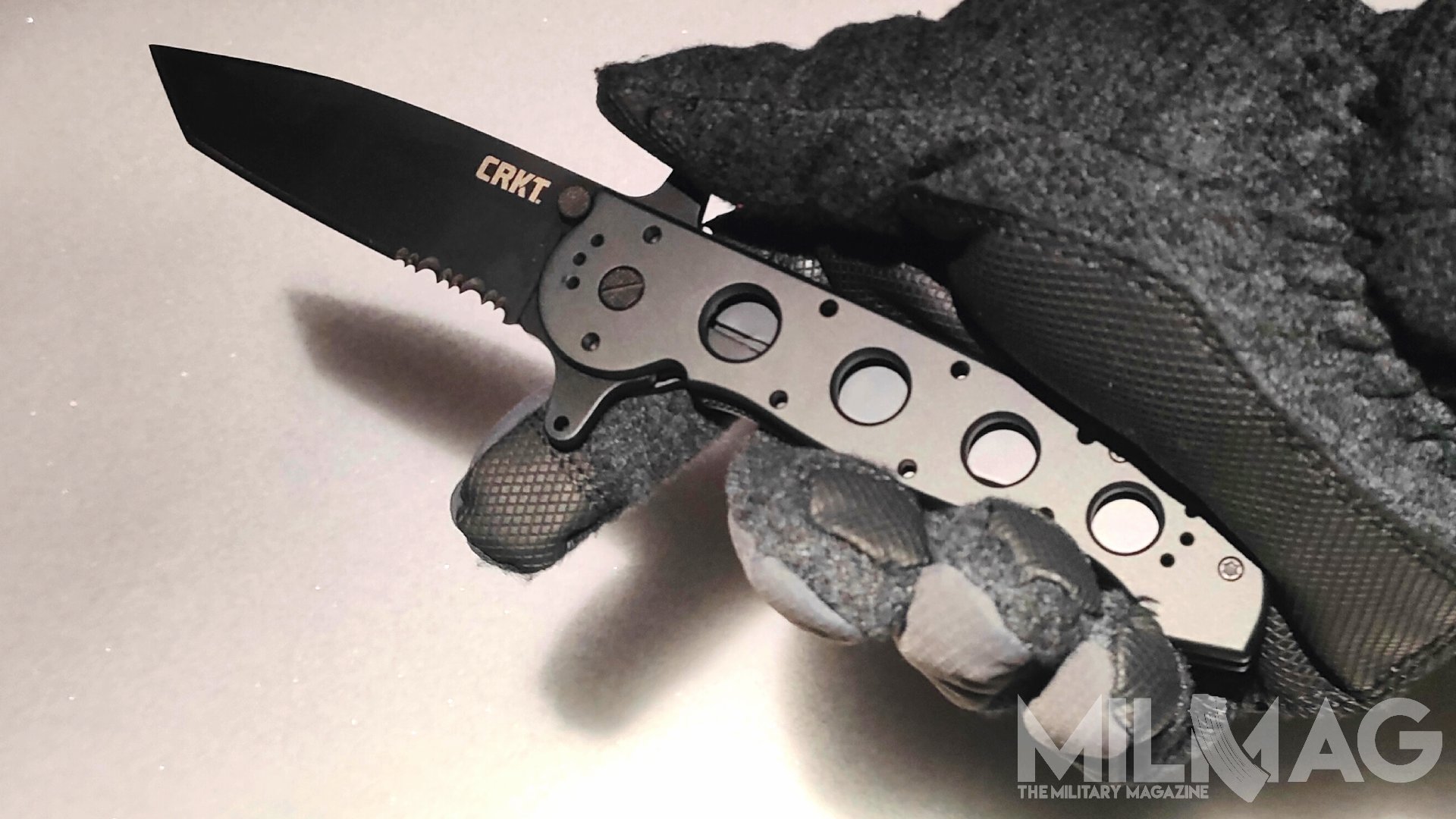 nóż crkt m16-14sf trzymany w dłoni w zimowej rękawicy
